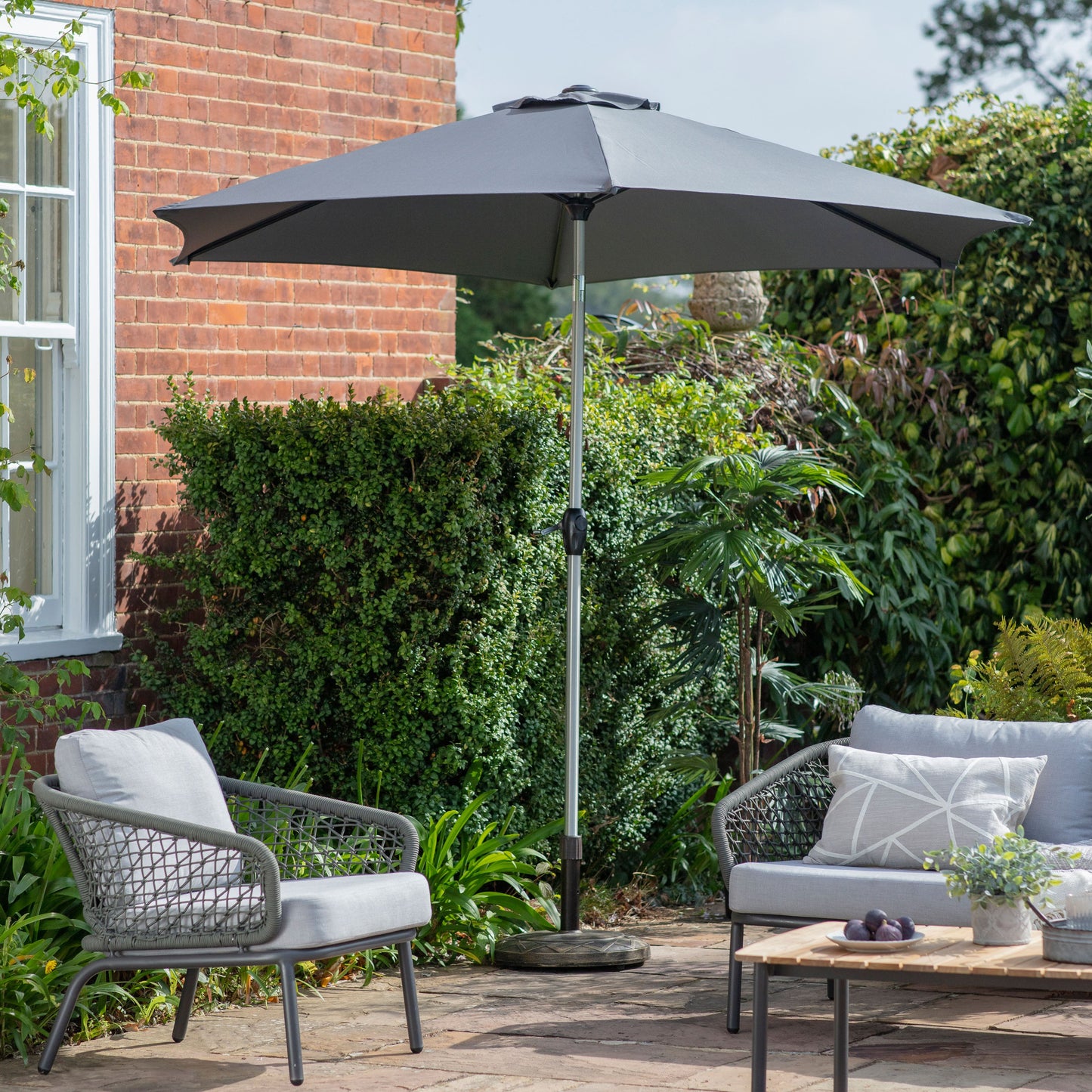 A grey patio set with a Alwington 2.7m Parasol Grey for home furniture.