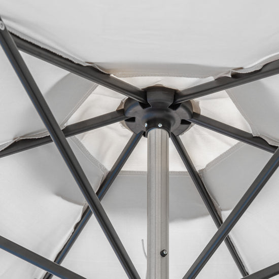 A close up of an Alwington 2.7m Parasol Grey with a black pole for interior decor.