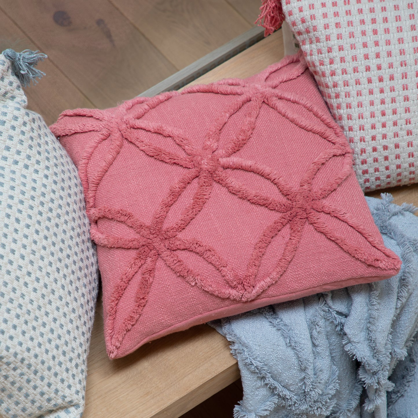 Load image into Gallery viewer, A tufted coral pillow with tassels, perfect for home decor.
