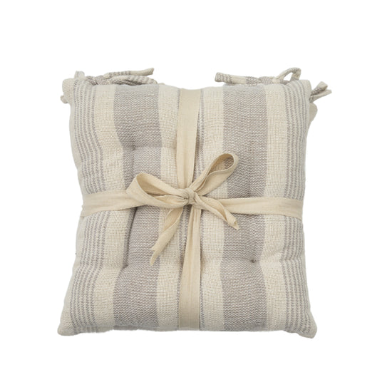 A striped seatpad pillow with a ribbon tied around it, perfect for interior decor or home furniture.