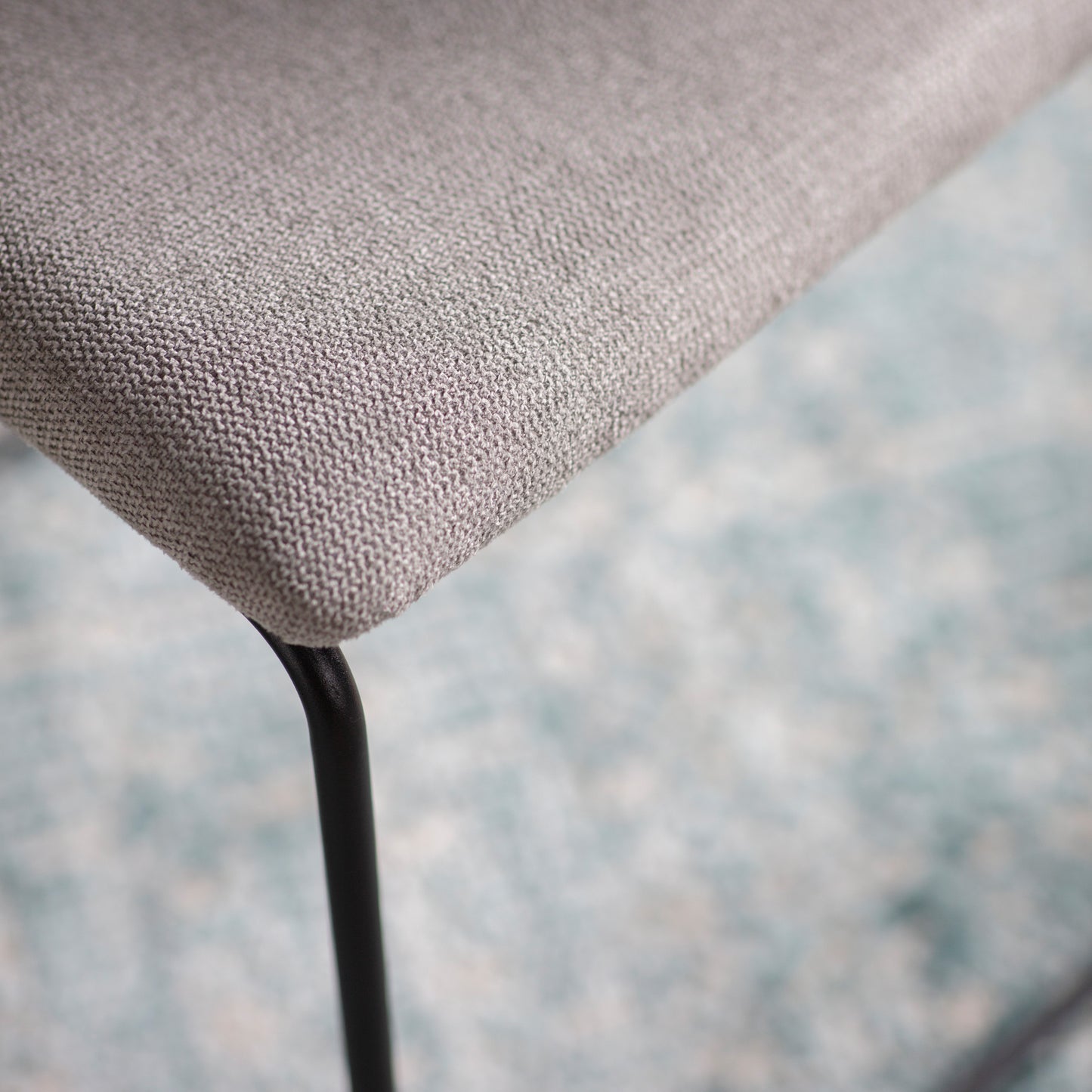 A close up of a Chivelstone Dining Chair Light Grey (2pk) by Kikiathome.co.uk on a blue rug, showcasing interior decor and home furniture.