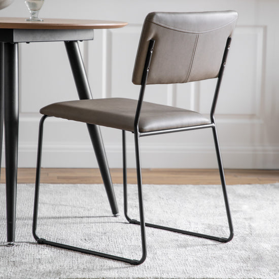 A Chivelstone Dining Chair Silver Grey (2pk) by Kikiathome.co.uk perfect for home furniture and interior decor with a metal frame and leather seat.