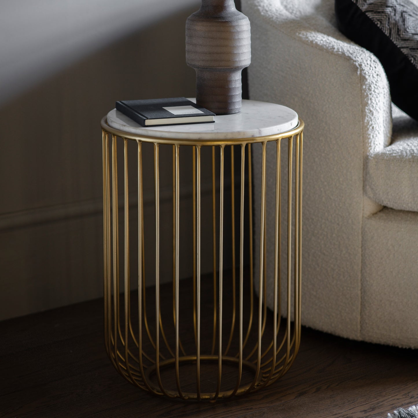 A gold Riley side table by Kikiathome.co.uk, perfect for interior decor and showcasing a vase.