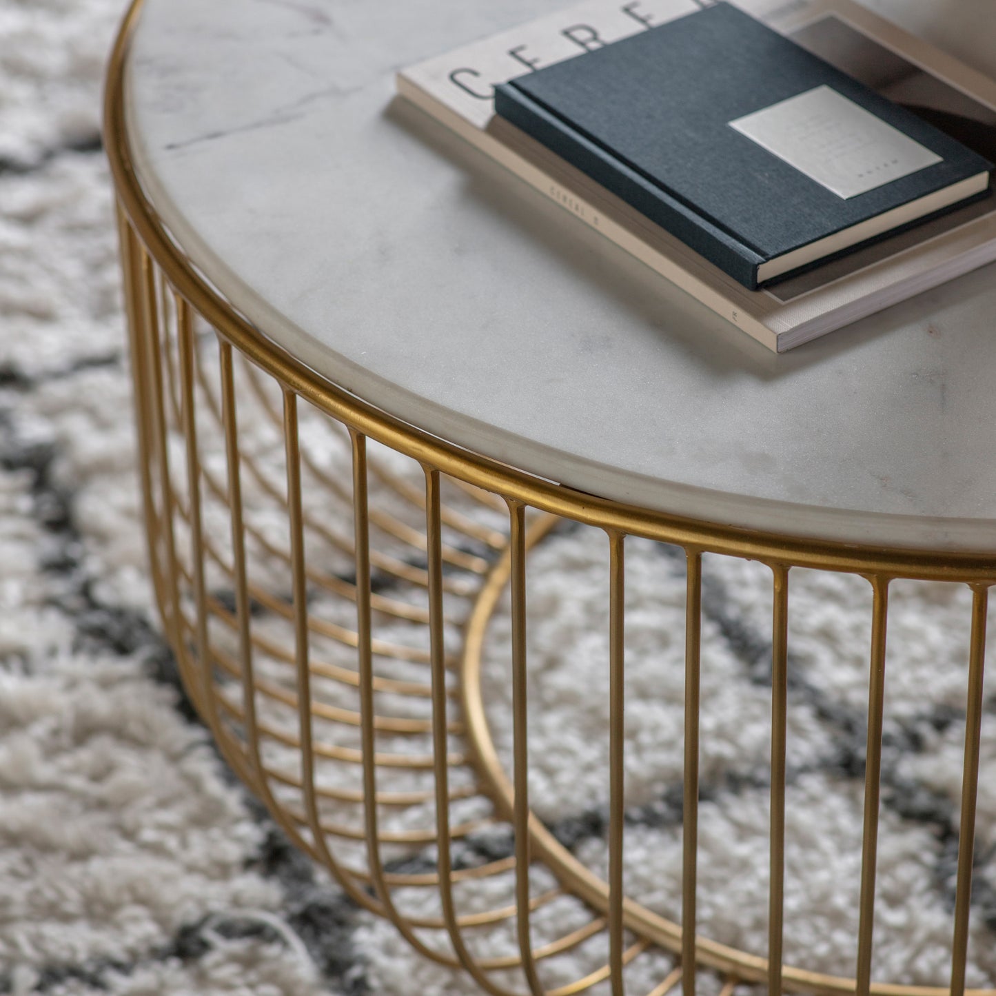 An interior decor statement piece, the Riley Coffee Table Gold from Kikiathome.co.uk beautifully showcases a book.