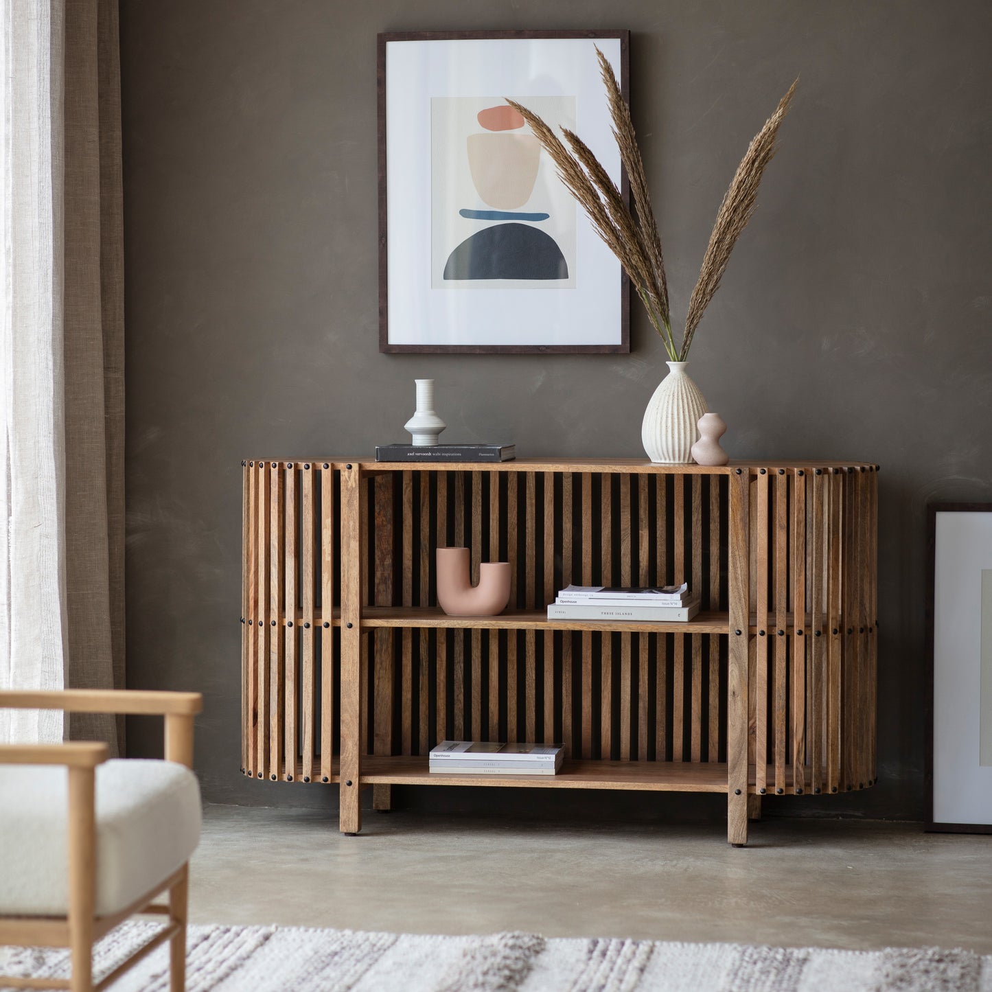 A Voss Slatted Console Table 1400x400x700mm by Kikiathome.co.uk enhances the interior decor of a living room.