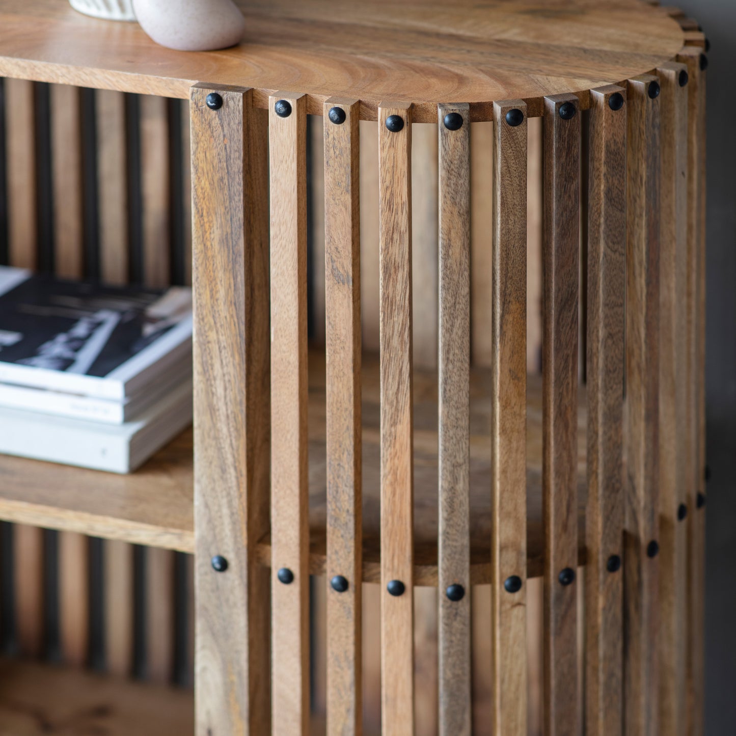 A Voss slatted console table from Kikiathome.co.uk adorned with books and a vase, perfect for interior decor.