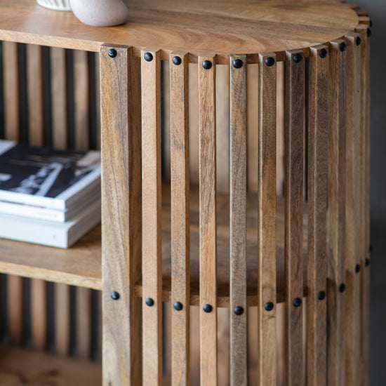 Load image into Gallery viewer, A Voss slatted console table from Kikiathome.co.uk adorned with books and a vase, perfect for interior decor.
