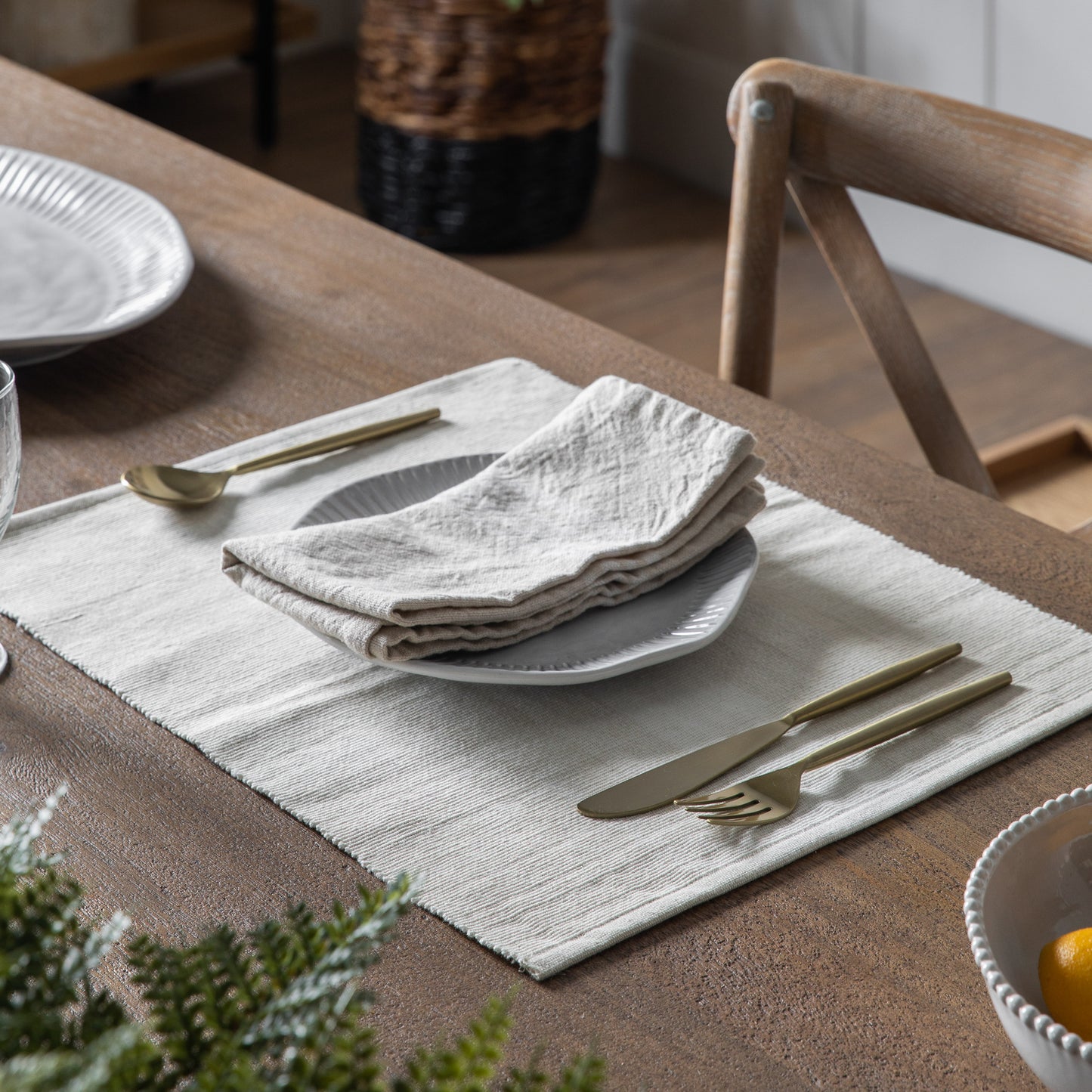 A dining table with an Ombre Ribbed Placemat Natural 450x350mm (4pk) from Kikiathome.co.uk, enhancing the interior decor of your home furniture setup