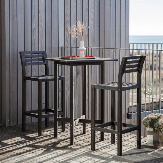 Alfrington Bar Stools Black (2pk) by Kikiathome.co.uk atop a balcony, enhancing the interior decor and providing home furniture with a view of the ocean.
