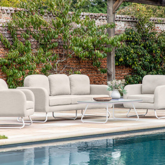 A Topsham 5 Seater Lounge Set Linen, a home furniture from Kikiathome.co.uk, placed next to a swimming pool.