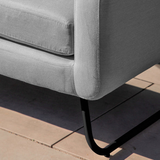 A Topsham Corner Lounge Set Slate with black legs on a sidewalk for interior decor.