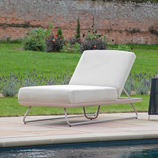 A Topsham Sun Lounger Linen by Kikiathome.co.uk adding a touch of interior decor to a poolside setting.