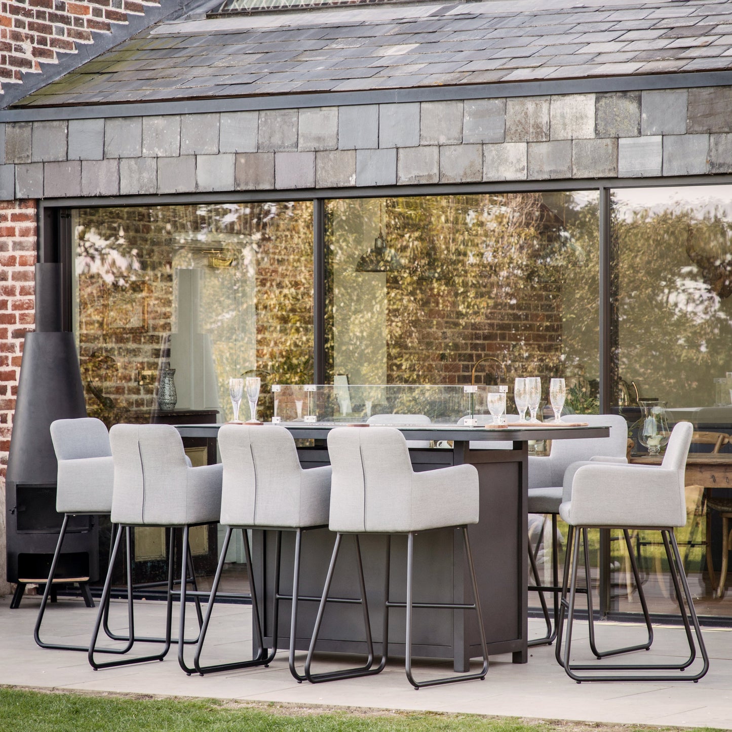 Load image into Gallery viewer, A patio with a Ferrers 8 Seater Bar Set from Kikiathome.co.uk, enhancing interior decor.
