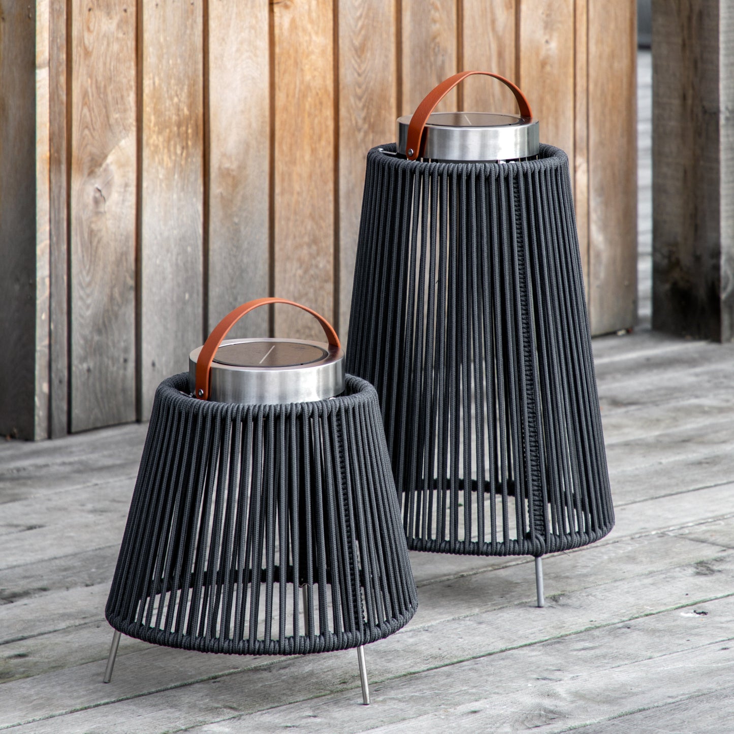 Two Marldon LED Solar Lantern Small from Kikiathome.co.uk enhance the interior decor of a wooden deck.