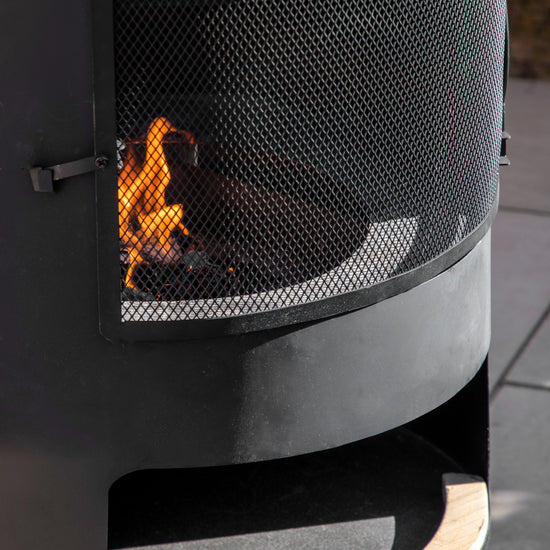 Load image into Gallery viewer, A Monkleigh Chiminea from Kikiathome.co.uk featuring a pizza shelf adds to the interior decor and complements home furniture.
