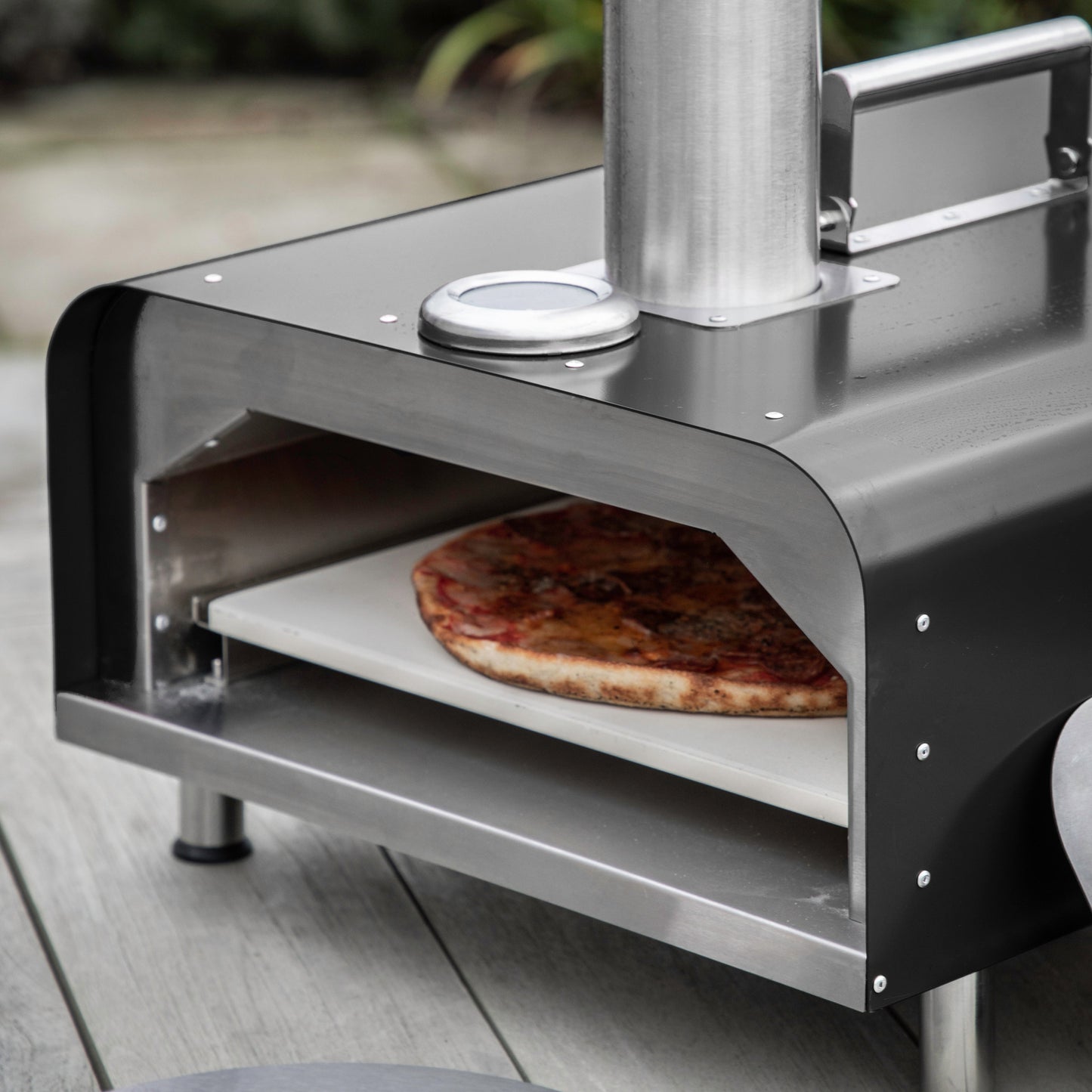 A stylish Brixham Pellet Pizza Oven Black from Kikiathome.co.uk that adds to your home's interior decor.