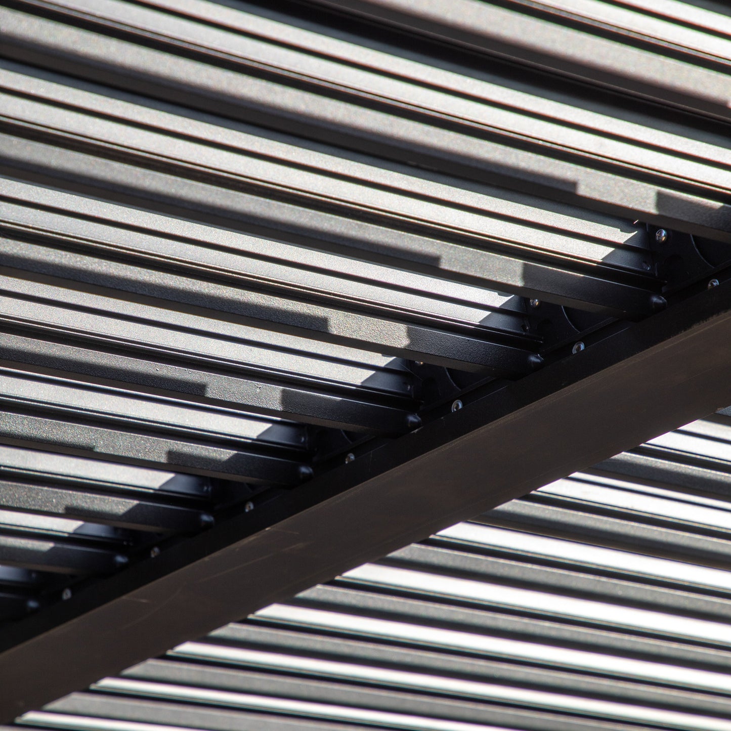 A close up of the Dittisham Pergola Black 3000x4000mm metal structure for interior decor/home furniture by Kikiathome.co.uk.