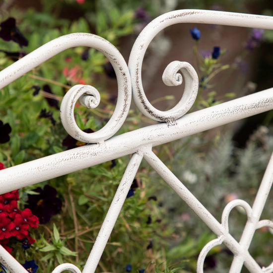 A close up of the Farringdon Outdoor Bench Vanilla by Kikiathome.co.uk, a white wrought iron garden bench suitable for interior home decor and outdoor use.