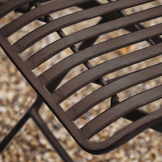 A close up of a Portlemouth 4 Seater Bistro Set Noir chair for interior decor from Kikiathome.co.uk.