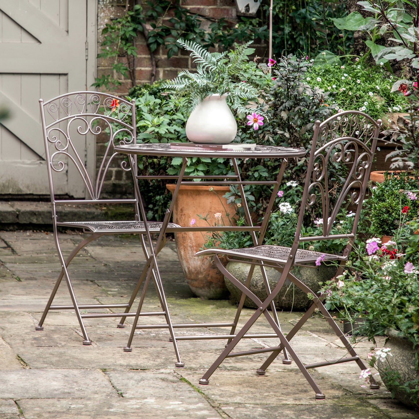 A Roborough 2 Seater Bistro Set Noir by Kikiathome.co.uk, perfect for home furniture and interior decor in a garden.