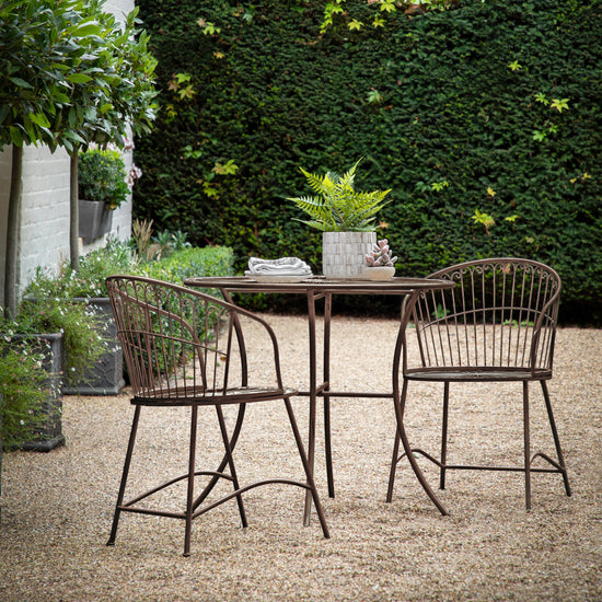 A Branscombe 2 Seater Bistro Set Noir for home furniture and interior decor in a garden.
