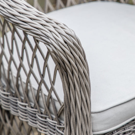 A close up of an Allington Bistro Set Stone wicker chair with a cushion, perfect for interior decor or home furniture from Kikiathome.co.uk.