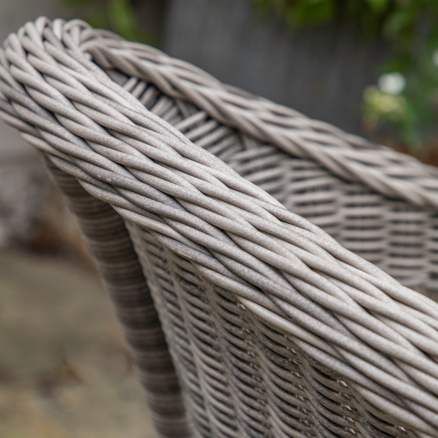 A close up of the Allington Bistro Set Stone wicker chair perfect for interior decor and home furniture.