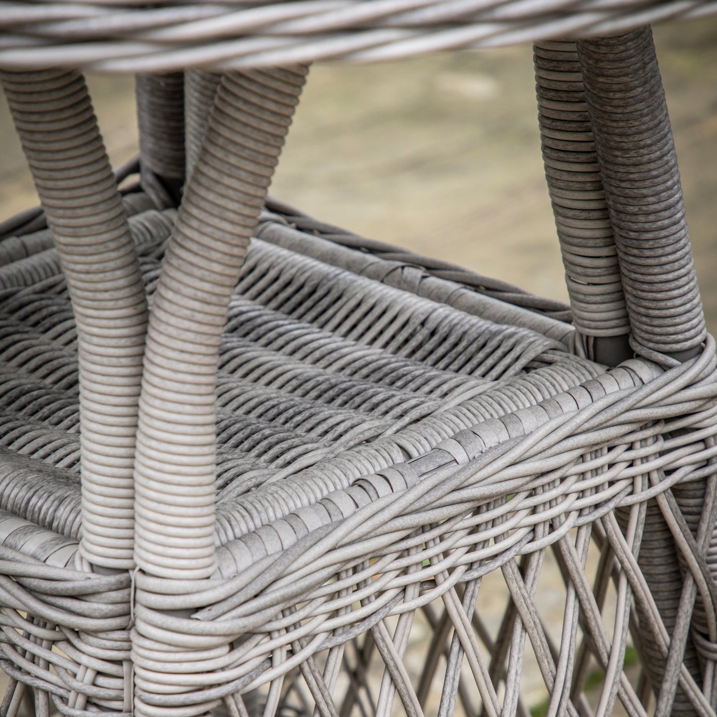 A close up of the Allington Bistro Set Stone by Kikiathome.co.uk, a grey wicker table perfect for interior decor.