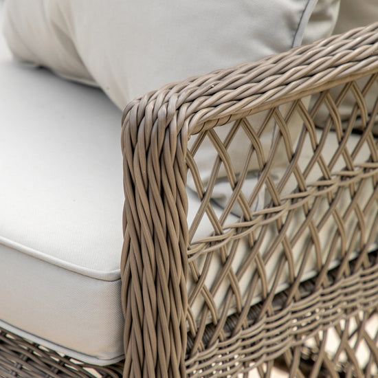 A close up of a Ringmore Lounge Set wicker outdoor chair, perfect for home furniture and interior decor, from Kikiathome.co.uk.