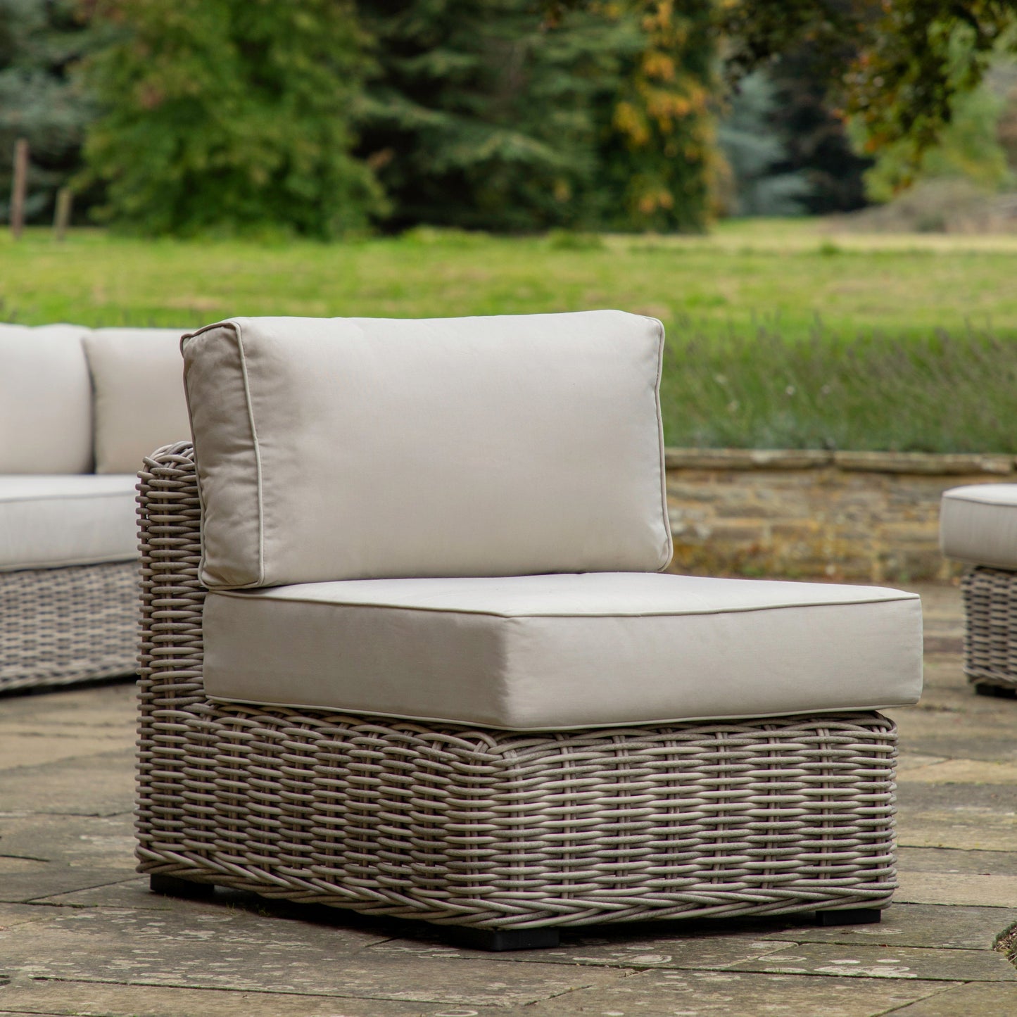 A set of Churchstow 1 Seater Module home furniture from Kikiathome.co.uk sitting on a stone patio.