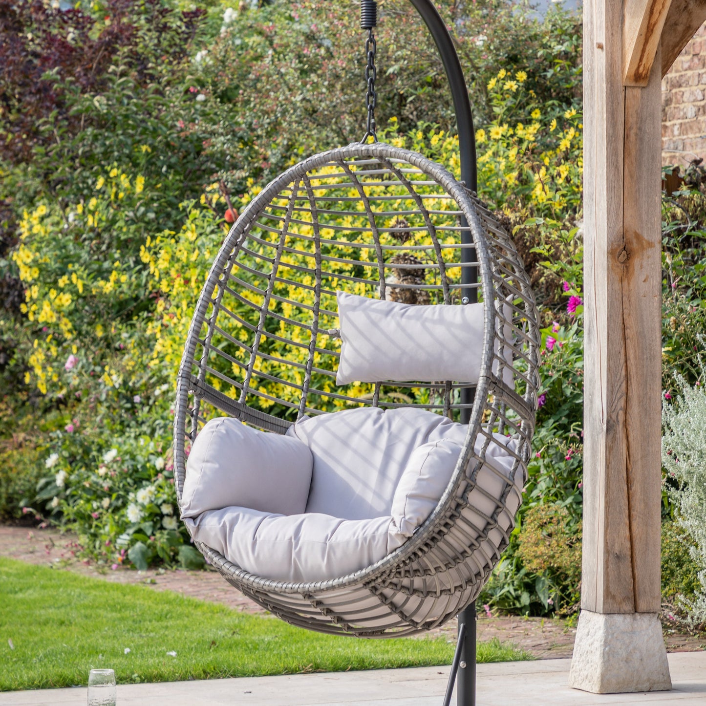 A Woodleigh Hanging Chair by Kikiathome.co.uk adds charm to a garden.