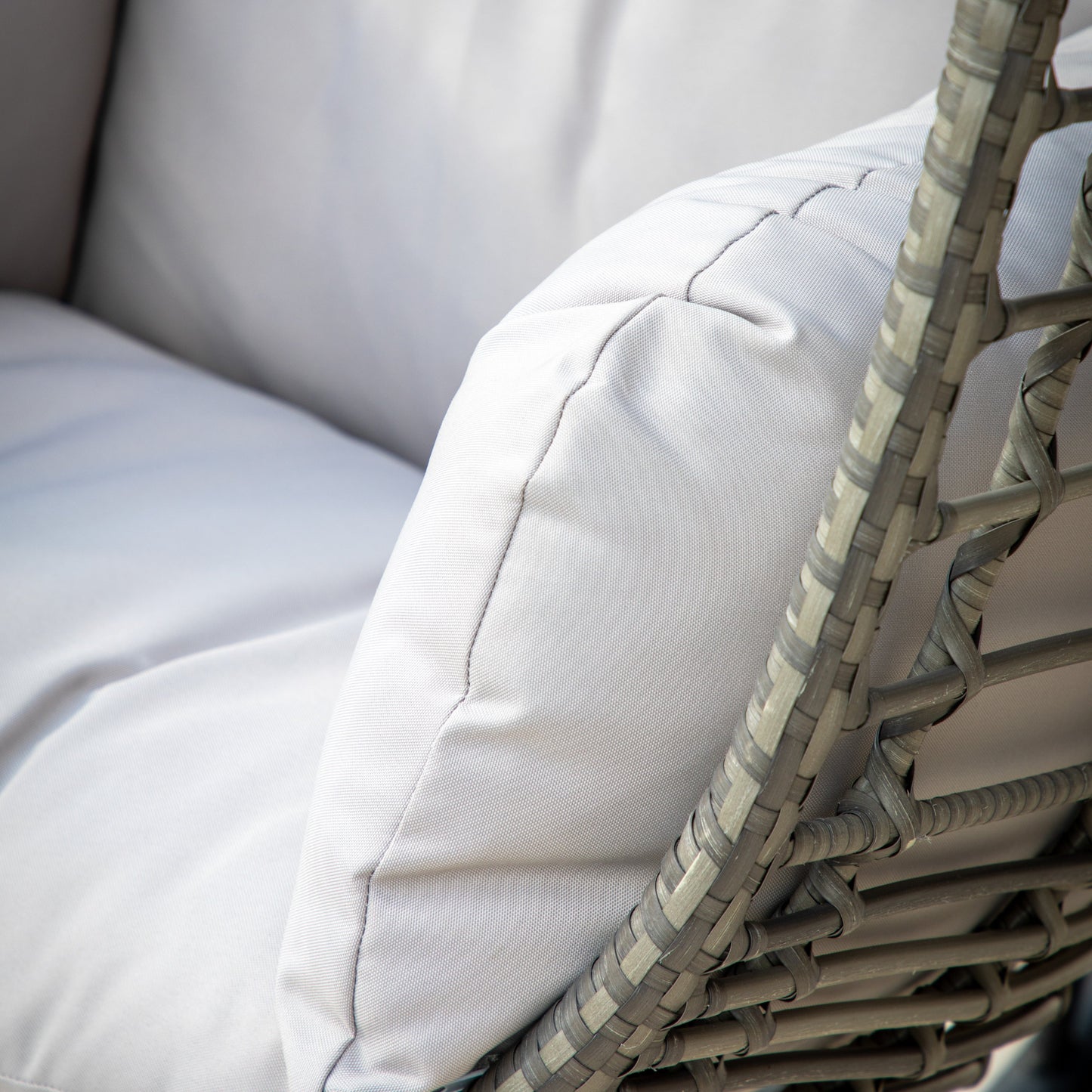 A close up of a white cushion on a stylish Woodleigh Hanging Chair for interior decor.