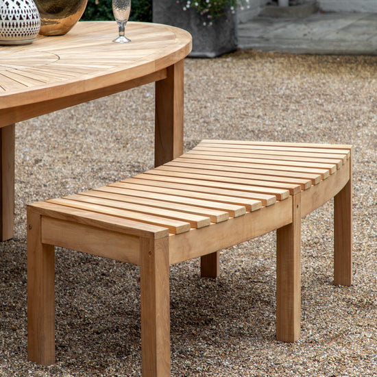 A Kikiathome.co.uk home furniture piece, the Ottery Bench 1480x630x450mm, adds style to interior decor on a gravel patio.