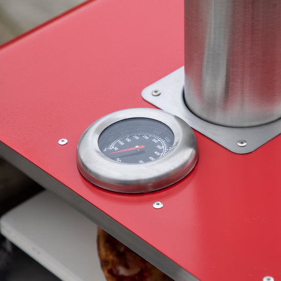 A Brixham Pellet Pizza Oven Red from Kikiathome.co.uk featuring a thermometer, perfect for interior decor.