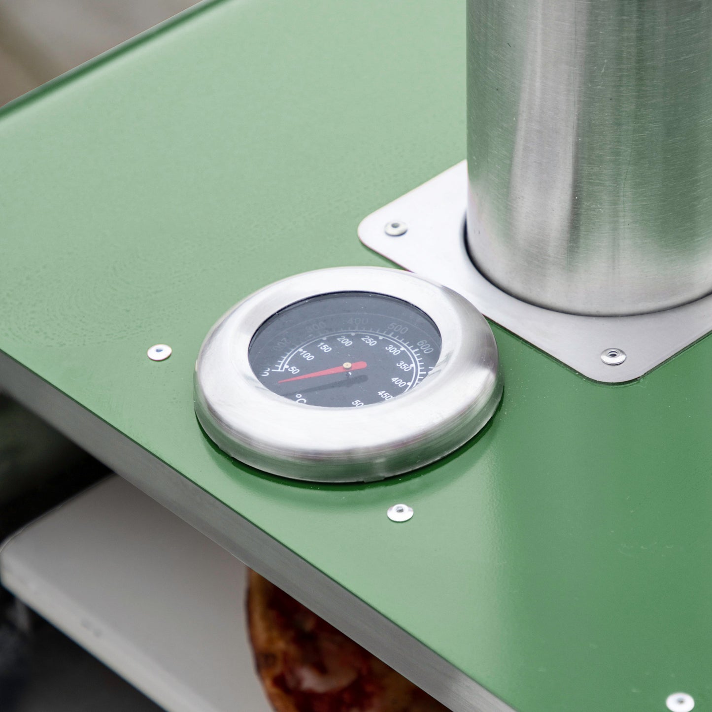 A Brixham Pellet Pizza Oven Green with a thermometer on it, perfect for interior decor or home furniture.