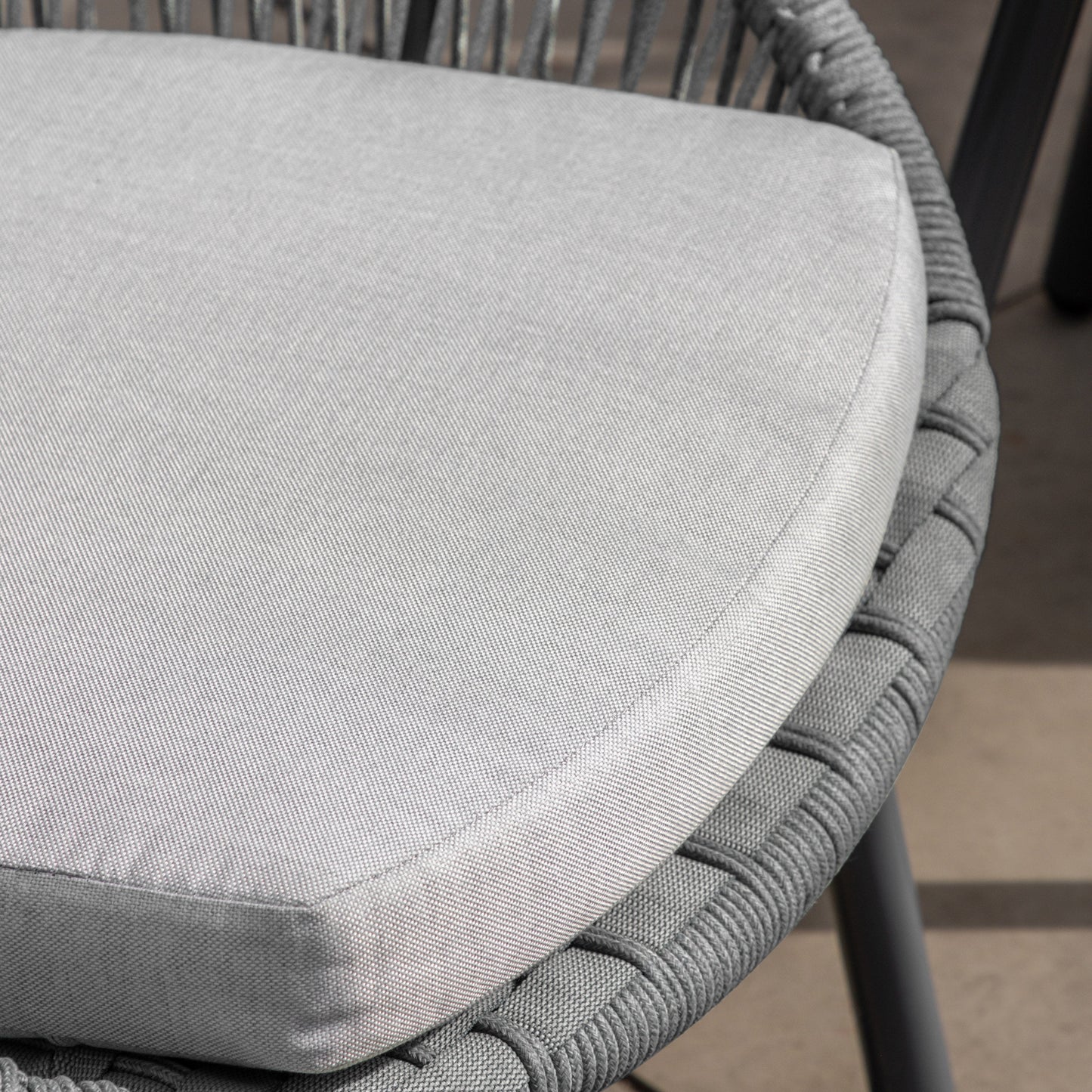A close up of a grey cushion on the Lamerton 2 Seater Bistro Set Charcoal, perfect for home furniture and interior decor.