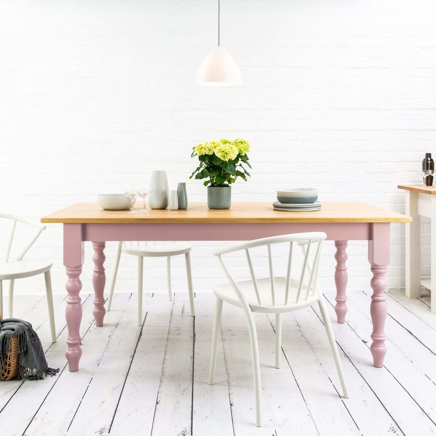 A pink French dining table with prime oak top and chairs in a white kitchen, perfect for home furniture and interior decor.