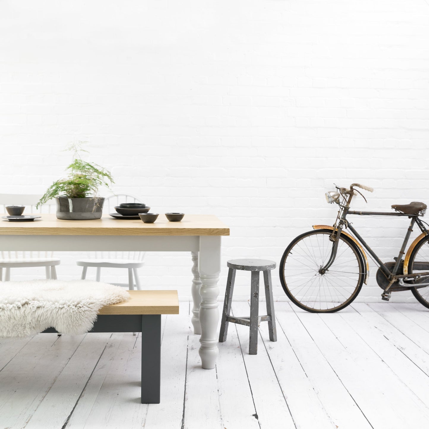 A Farmhouse Rustic Oak Dining Table with a bicycle parked in front, ideal for home furniture and interior decor.